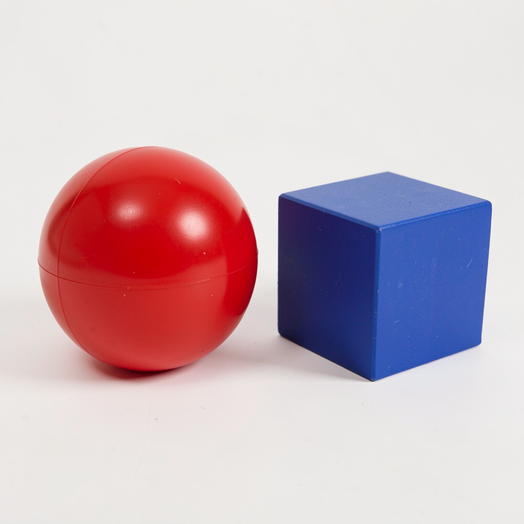 A red ball and a blue cube sitting side by side on a white s