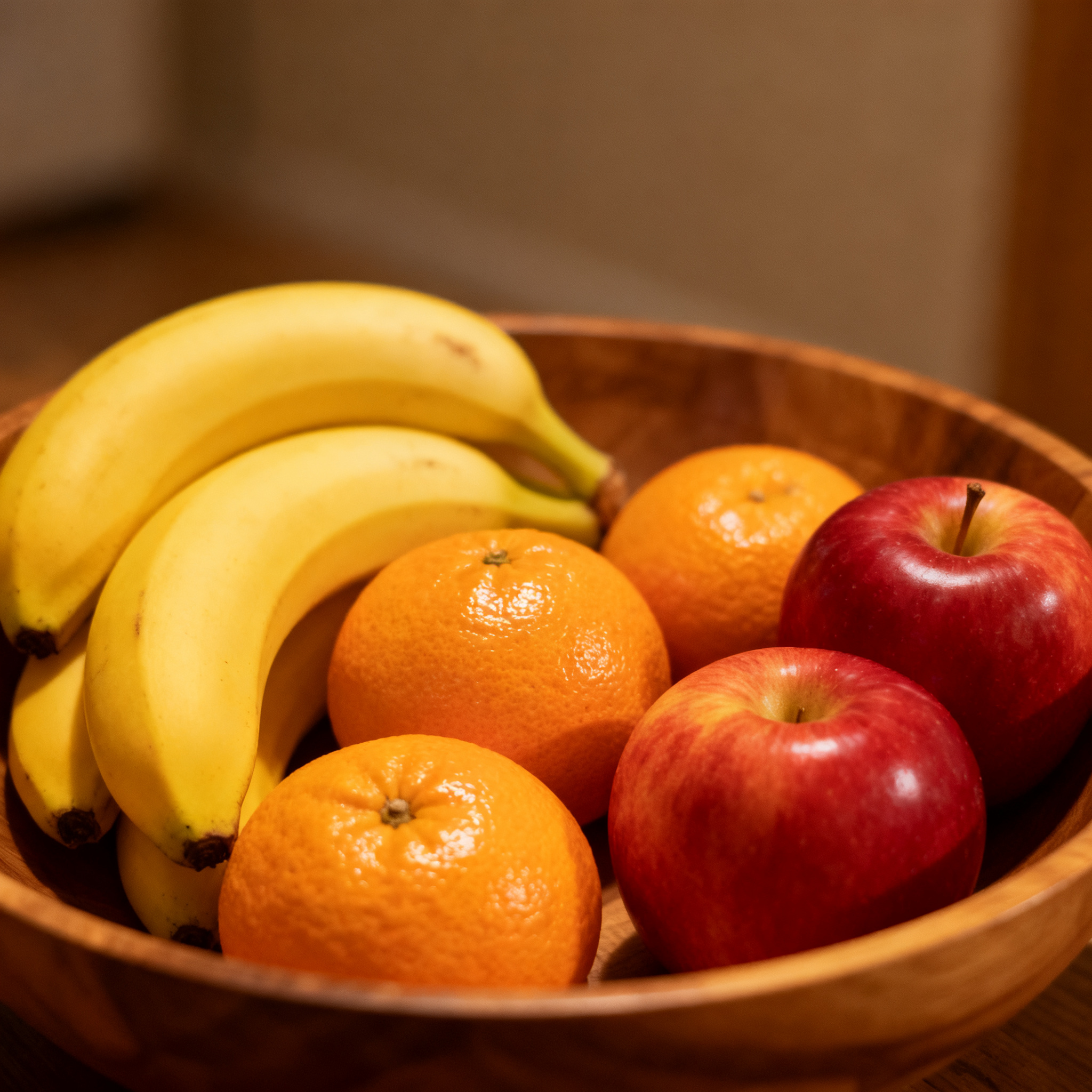 A fruit bowl containing exactly 3 bananas, 4 oranges, and 2 