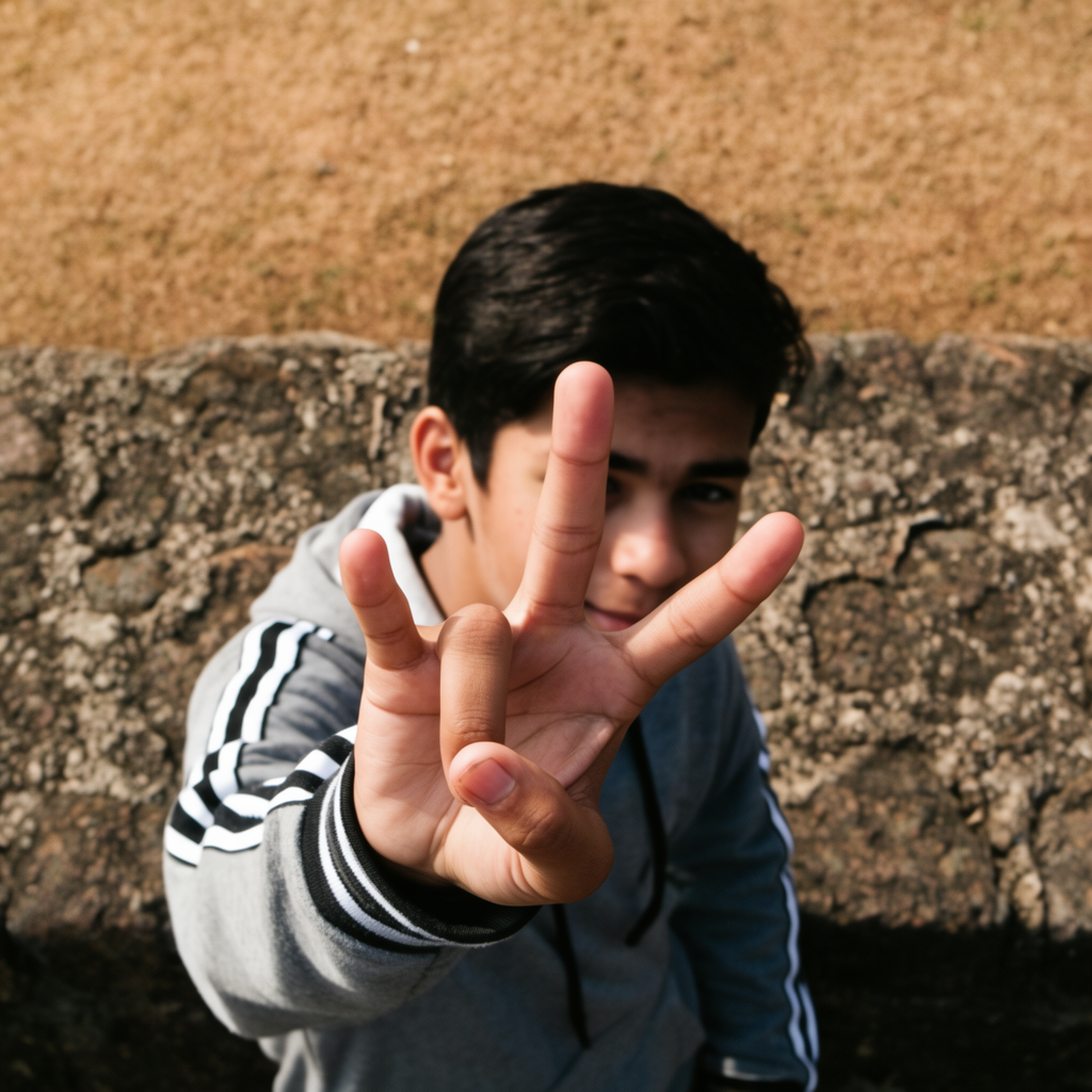 A person counting to three on their fingers, with index, mid