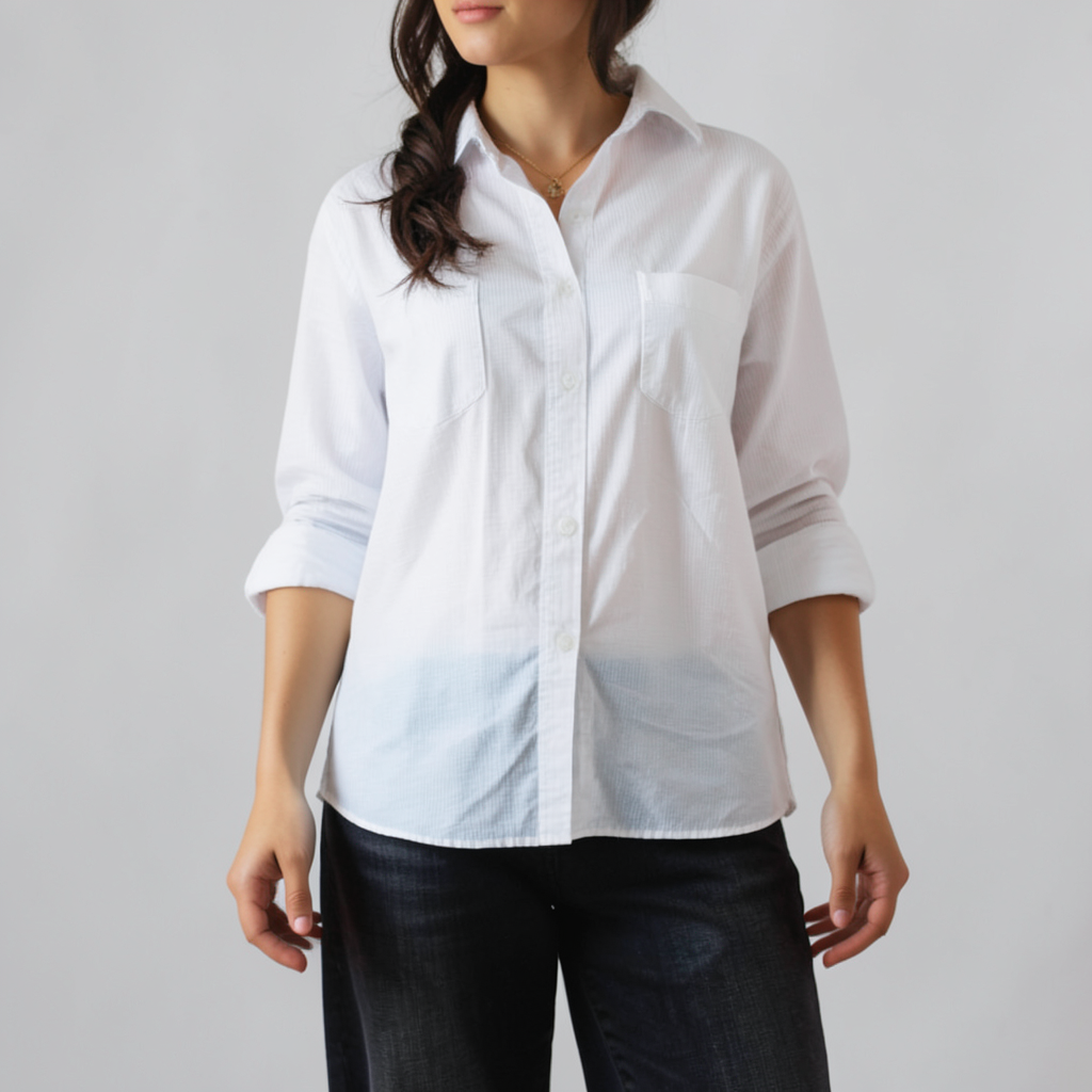 A person standing with both hands visible at their sides, fi