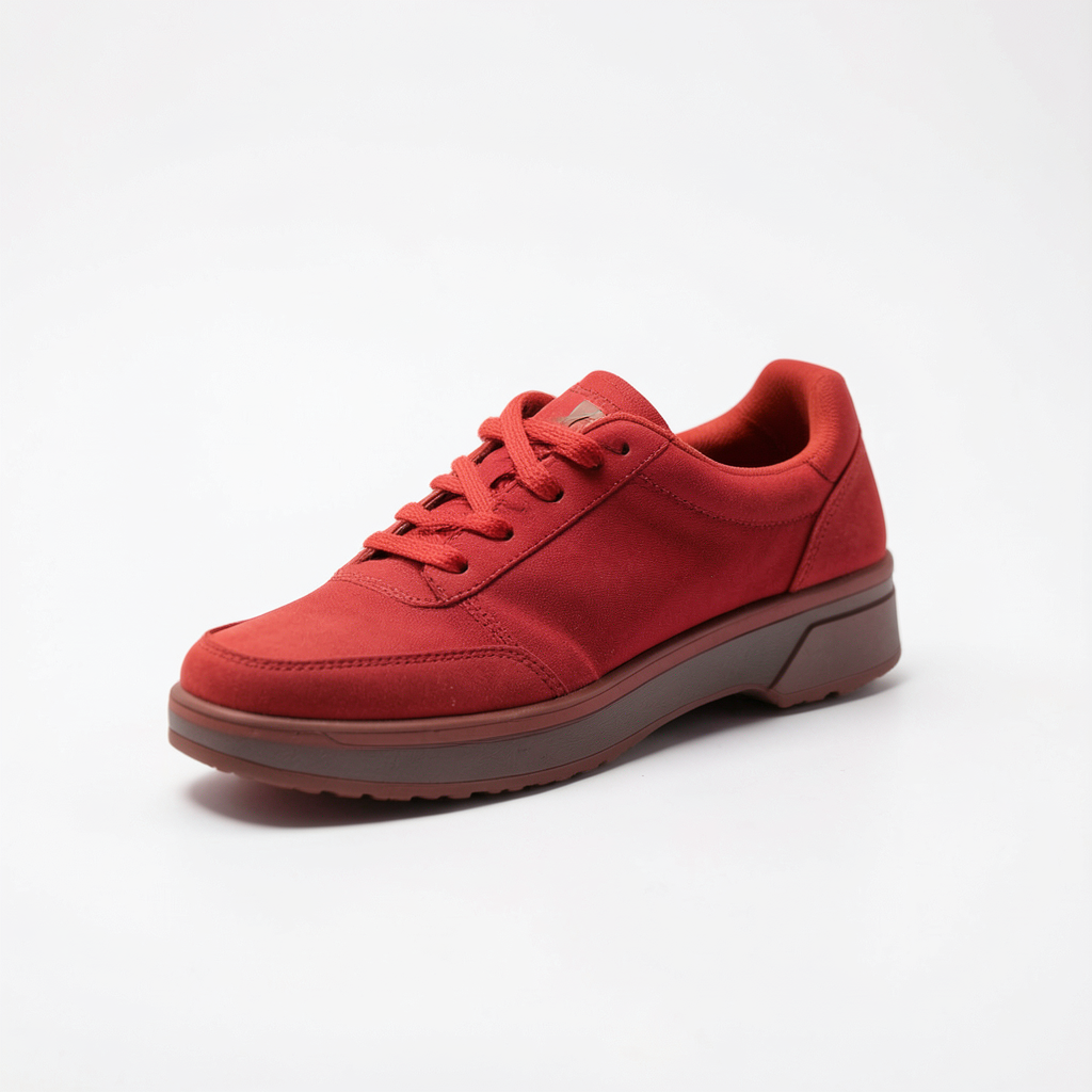 A single red sneaker on a clean white background with soft s