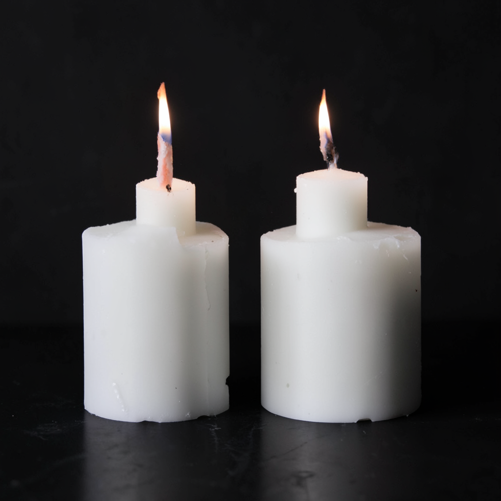 Exactly 4 white candles standing on a dark surface