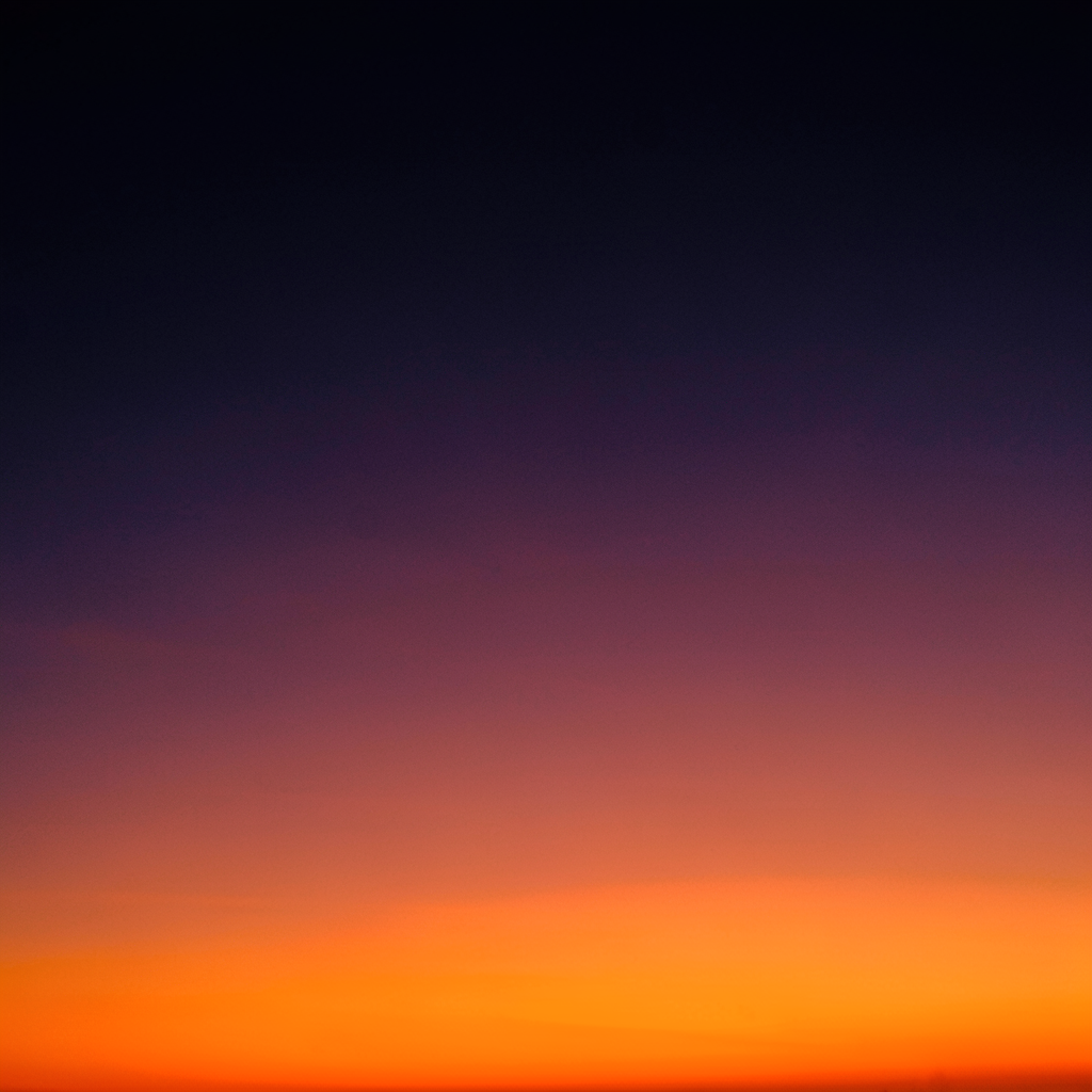 A sunset sky gradient on a flat surface from #FF6B35 (orange