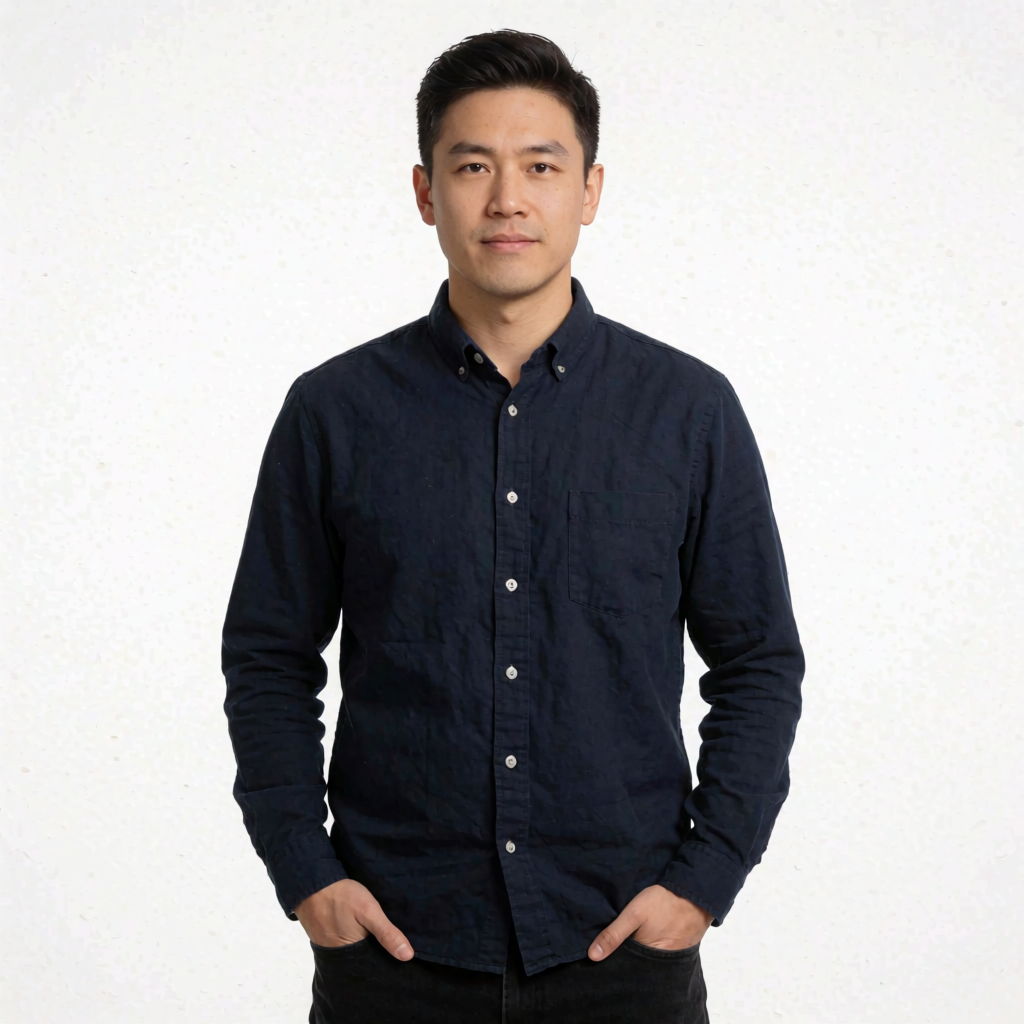 A man standing straight facing the camera, hands in pockets,