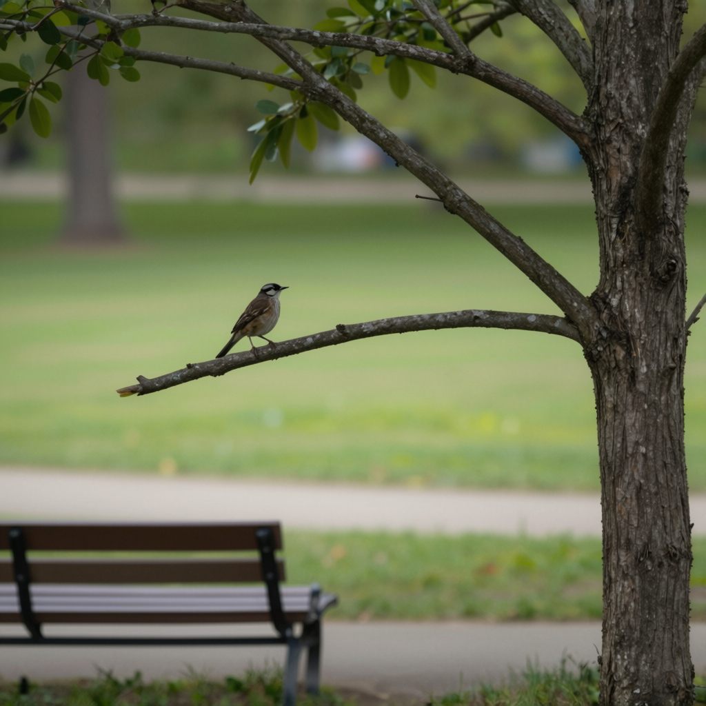 A bird perched on a branch, the branch extending from a tree