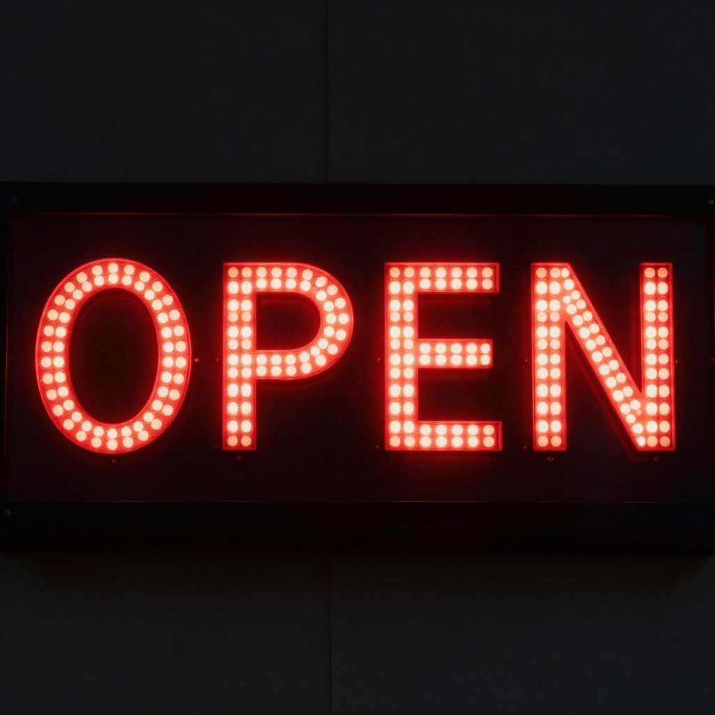 The word 'OPEN' displayed on a red LED sign with glowing pix